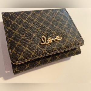 Dark brown wallet for women , light brown inside. It has space for coins